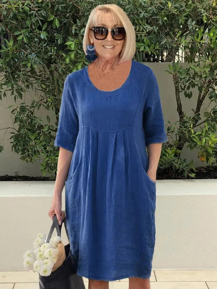 Luftiges Damen-Midikleid mit Rundhalsausschnitt, kurzen Ärmeln und Taschen für einen lässigen Sommer-Look.