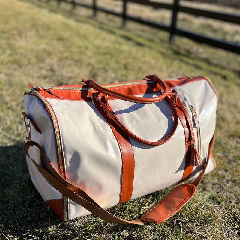 Person packt faltbare Anzugtasche Arno in Koffer; perfekte Reisetasche für knitterfreie Kleidung auf Reisen.