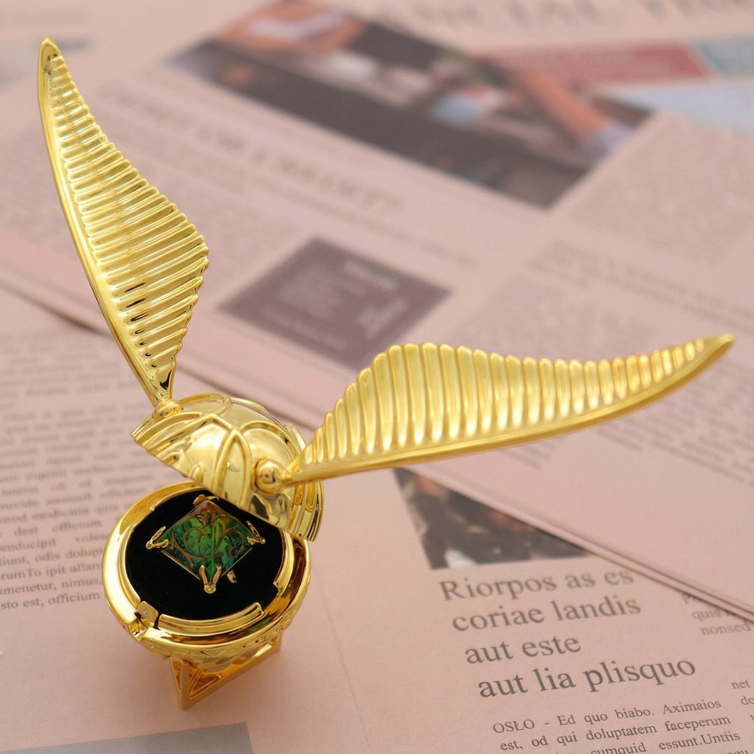 Nahaufnahme: Goldene Ringbox mit Flügelmechanik, offene Seitenflügel enthüllen den Ringhalter.