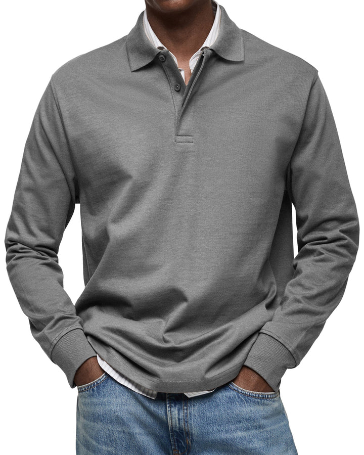 Mann trägt elegantes Langarm-Poloshirt mit Strukturkragen, ideal für ein gepflegtes Business-Outfit.