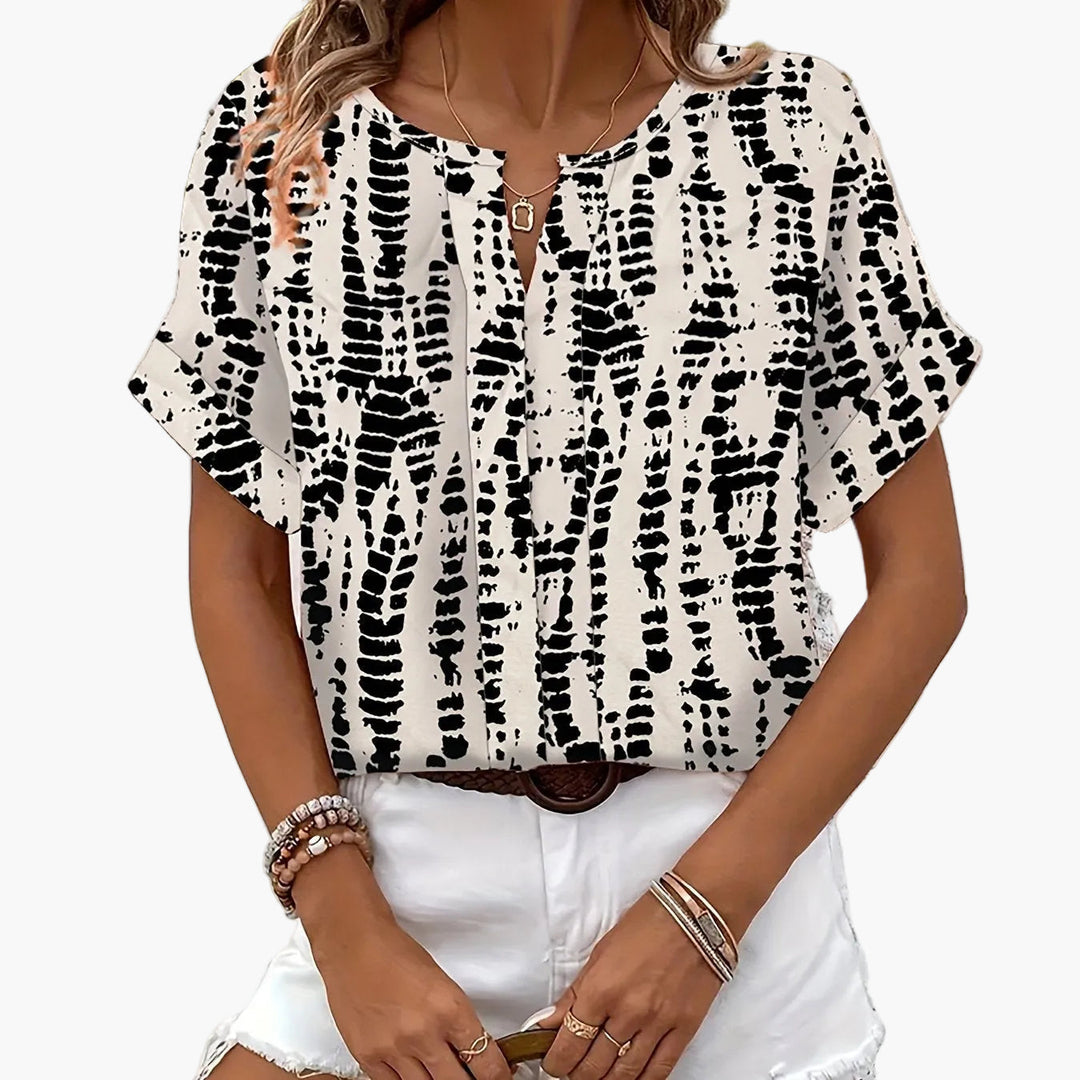 Elegantes Damen Top mit Kurzarm und modernem Allover-Print. Modisch und bequem.