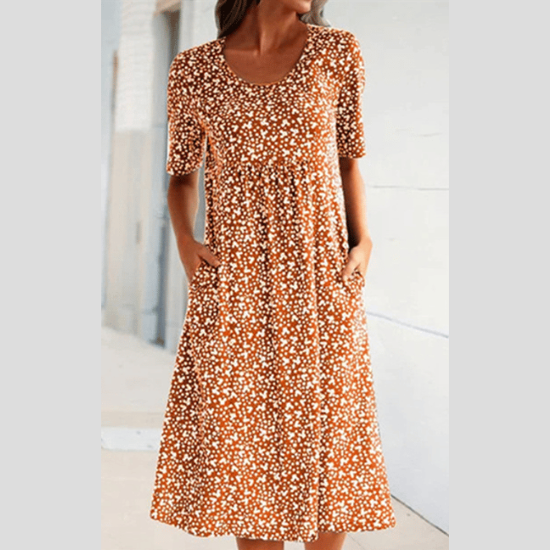 Freizeit-Midikleid für Damen im Sonnentanz-Stil. Lebhaftes Blumenmuster, A-Linie. Komfortabel für warme Tage.