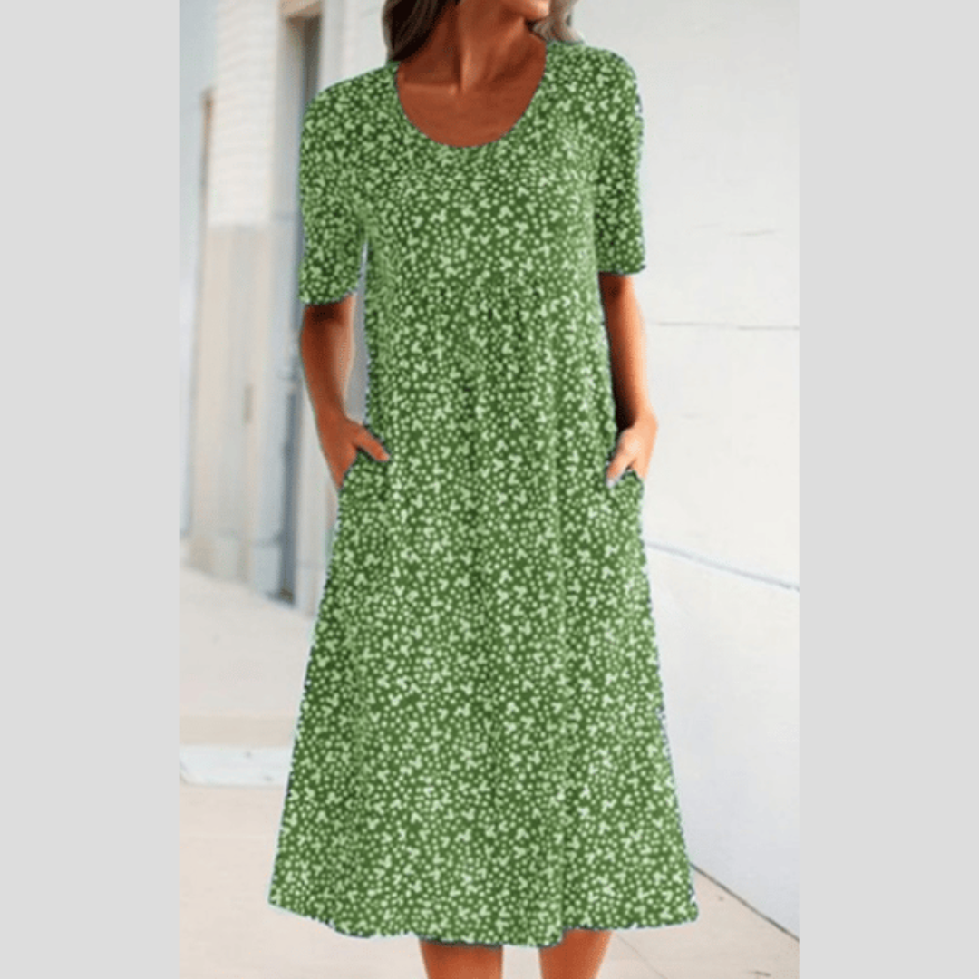 Schickes Damen Sommerkleid, Midilänge, mit Blumenmuster, kurzen Ärmeln und seitlichen Taschen. Komfortabel & modisch.