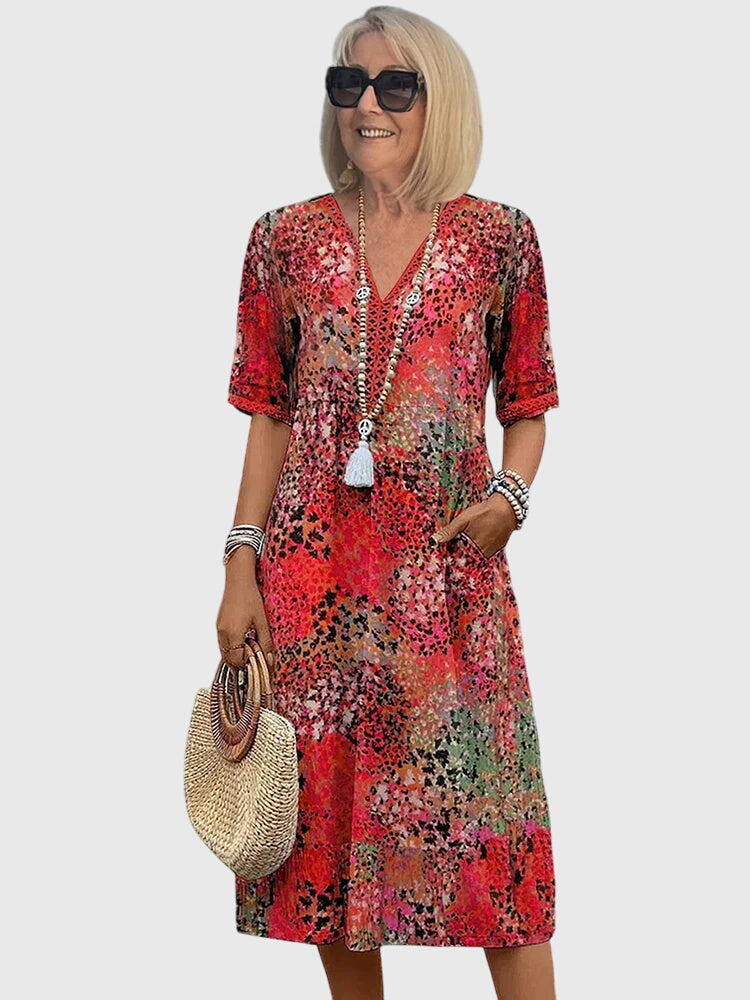 Nahaufnahme des fließenden Stoffes vom Damen Blumen Midikleid mit zartem floralem Muster, ideal für Frühling.