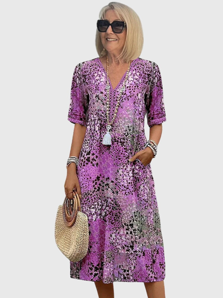 Lebhaftes florales Damen Midikleid mit leuchtendem Blumenmuster, perfekt für einen stilvollen Auftritt im Sommer.