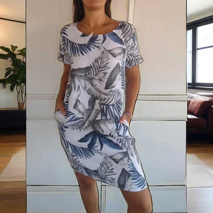Leichtes Damen Blumenkleid mit stilvollem botanischen Muster, Rundhalsausschnitt und seitlichen Taschen.