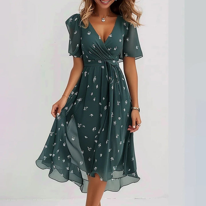 Detailansicht: Fließendes Damen Sommerkleid mit elegantem V-Ausschnitt, zartem Blumendruck und Kurzarmen, ideal für warme Tage.