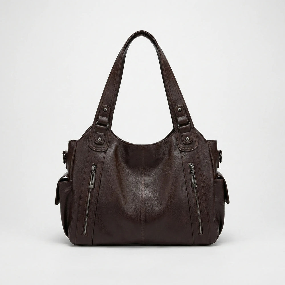Nikita Crossover Tasche in klassischem Schwarz, vielseitig als Schultertasche und Damentasche.