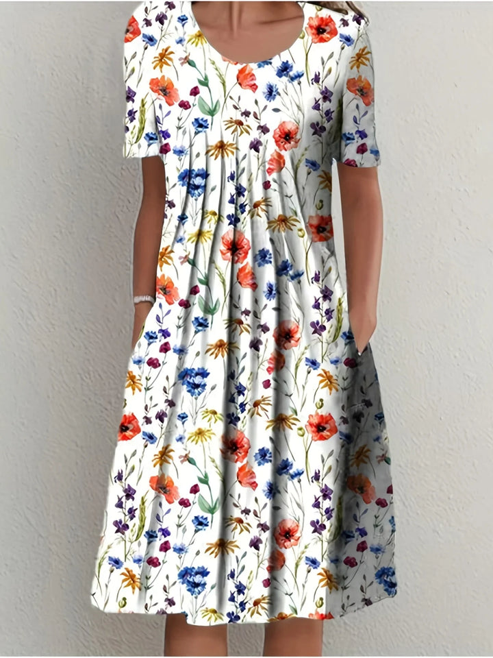 Damen Blumen Kurzarmkleid, elegant & fließend. Perfekter Sommer-Look für Gartenpartys und festliche Anlässe.
