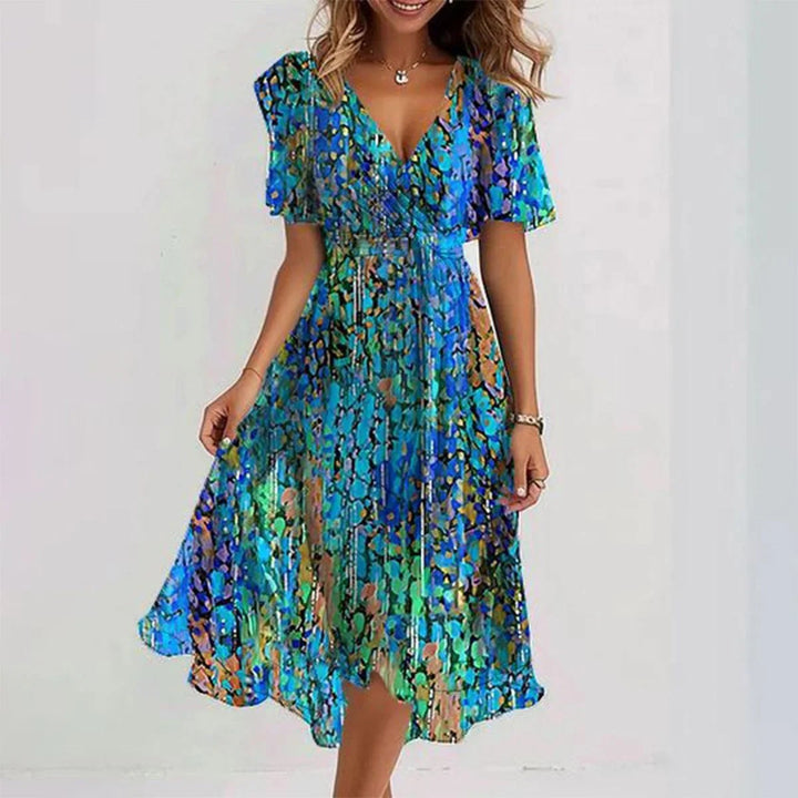 Damen Sommerkleid mit Wickeloptik, V-Ausschnitt & Flügelärmeln. Gemustertes, elegantes Freizeitkleid.