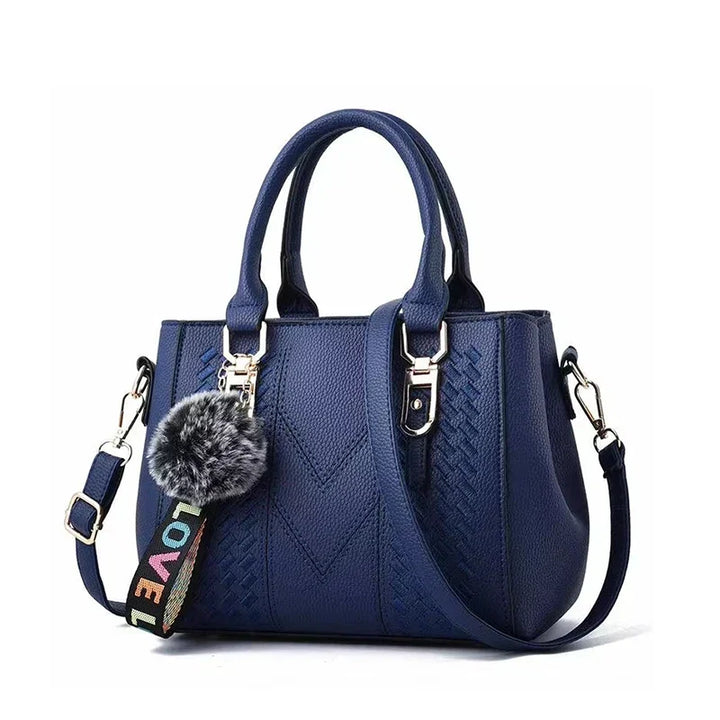 Elegante Damen Lederhandtasche mit modischem Pompon-Detail, perfekt für Alltag & Abend. Zeitloses Accessoire.