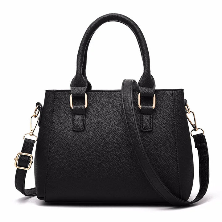 Rosa modische Damen Lederhandtasche mit charmantem Pompon. Ideal als elegante Umhängetasche für jeden Tag.
