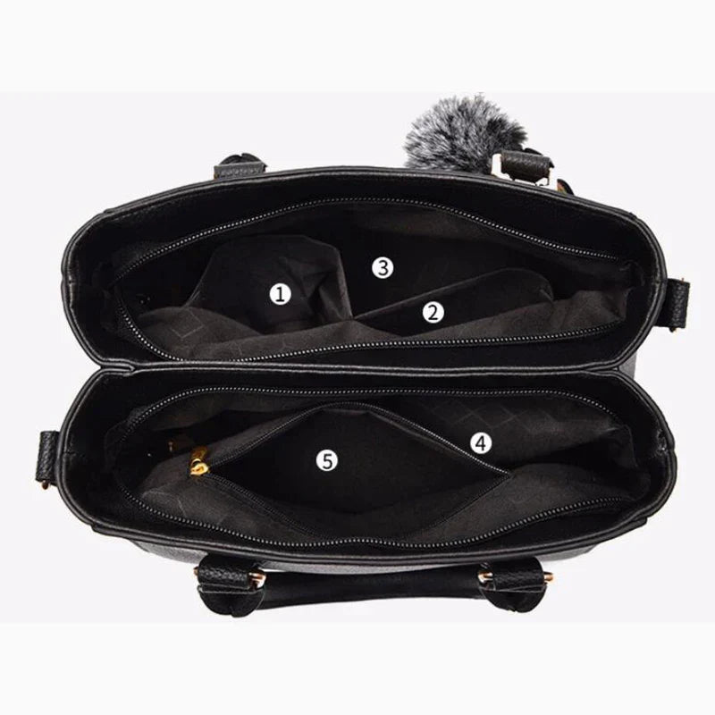 Praktische Damen Lederhandtasche mit Pompon, innen organisiert. Vielseitige Umhängetasche für Frauen.