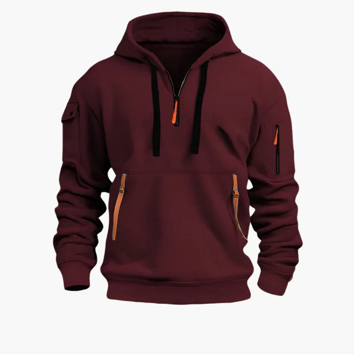 Funktionaler Herren-Hoodie im Utility-Style mit Half-Zip, Kapuze & praktischen Reißverschlusstaschen für Herrenmode.