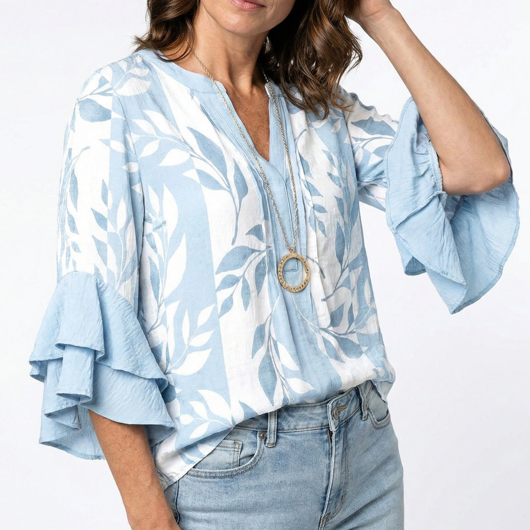 Damenbluse mit floralem Muster, Rüschenärmeln und langen Ärmeln. Eine elegante Sommer- und Frühlingsbluse.