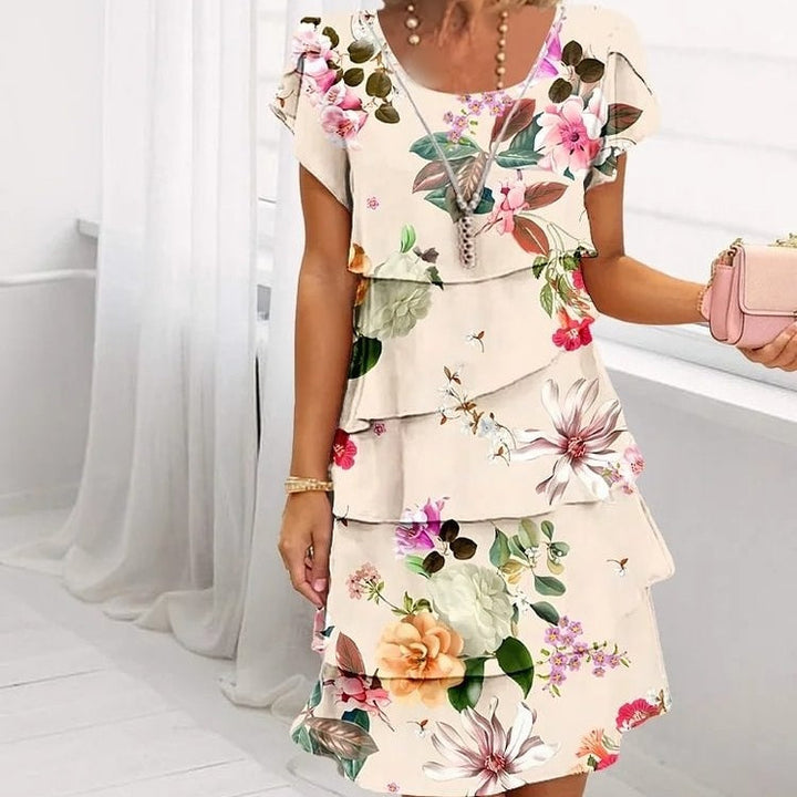 Damen Blumen Sommerkleid mit Rüschenlagen, elegant und luftig für warme Tage.