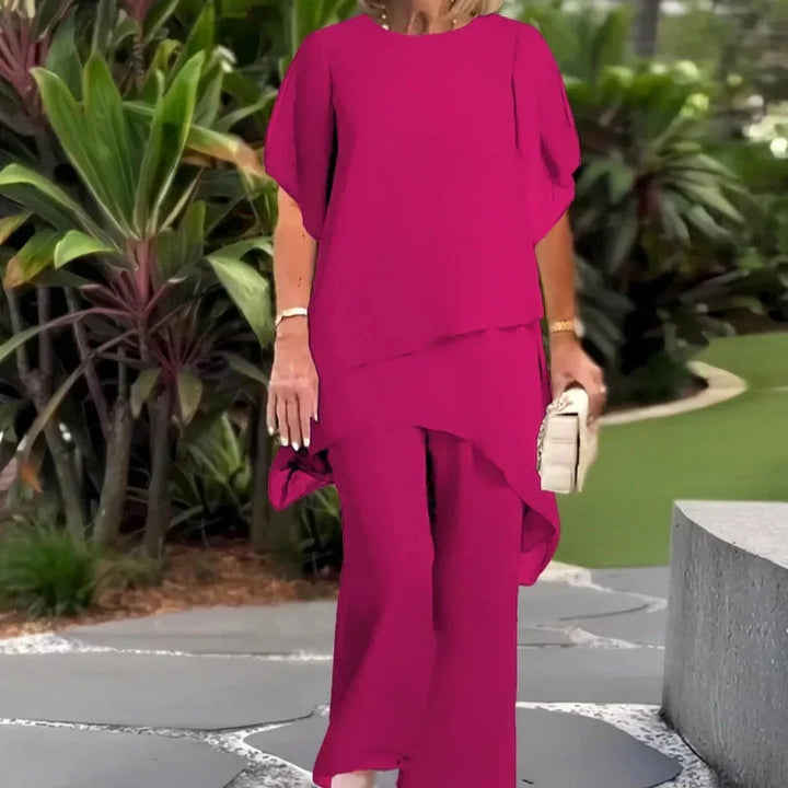 Eleganter fuchsia Zweiteiler: Damen-Set mit asymmetrischem Top & weiter Hose; stilvoller Business-Casual-Look.